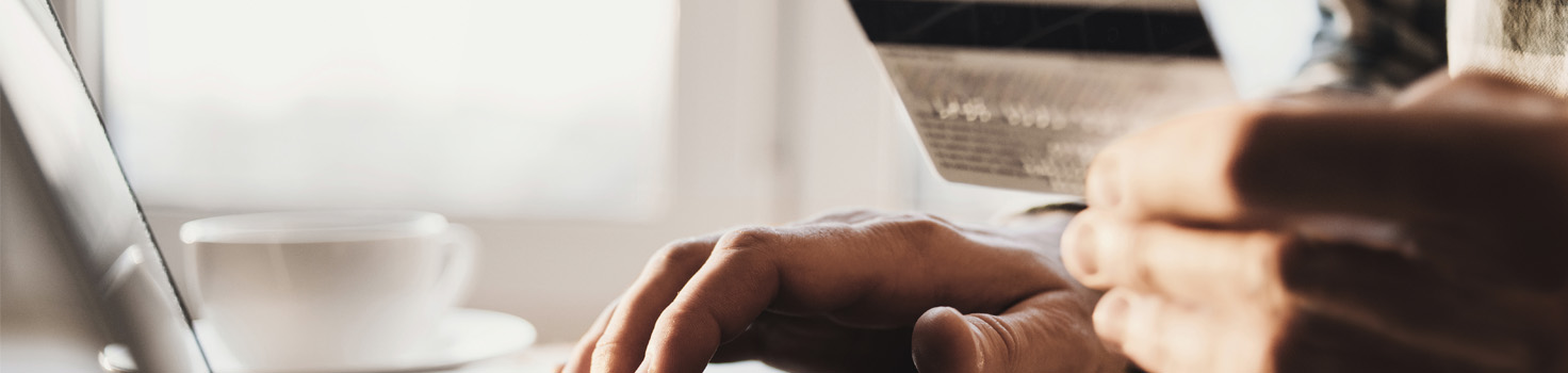Person on computer using credit card