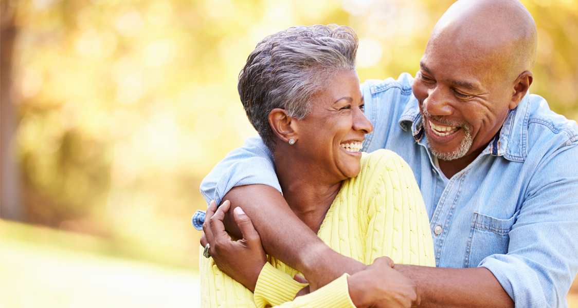 Senior Couple Relaxing In Autumn Landscape