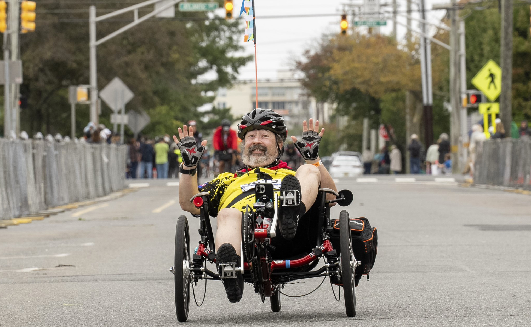 man riding recumbent bike smiles